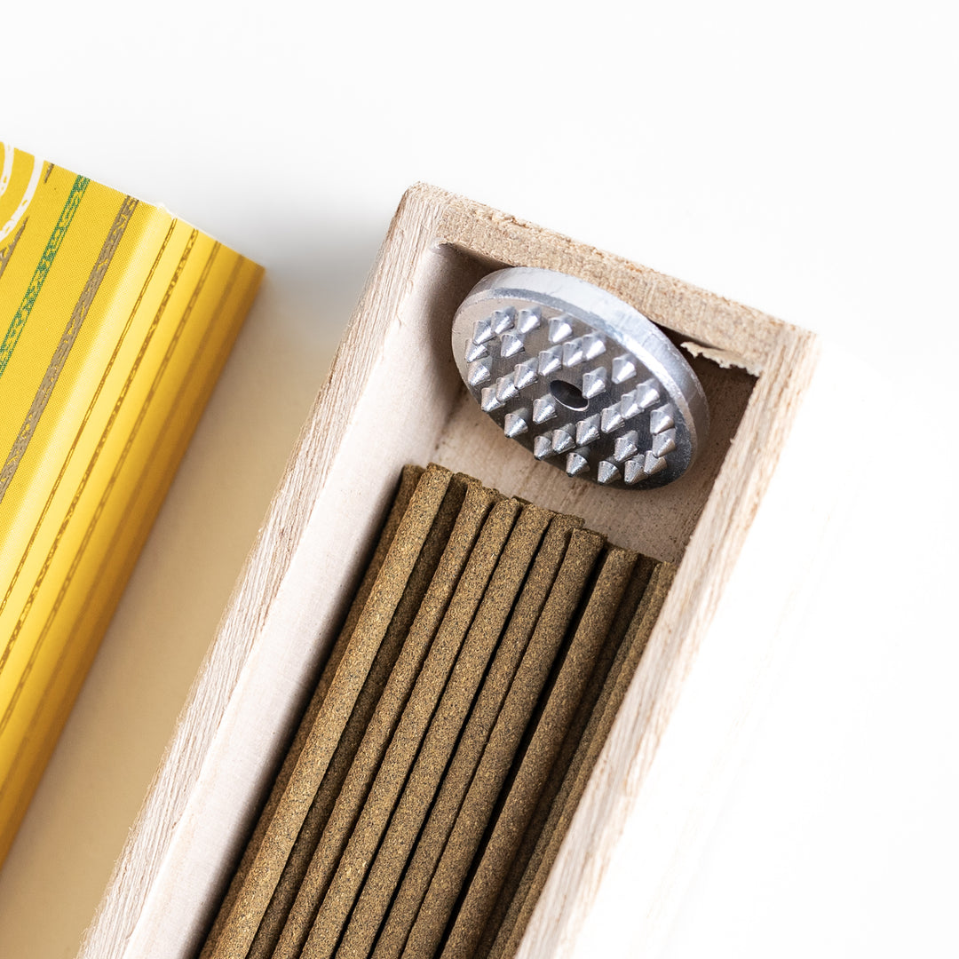 Zesty Yuzu Incense in a light wooden box with golden-yellow sticks, elegantly packaged in a vibrant yellow design featuring white circular patterns, evoking a bright and citrusy yuzu aroma.