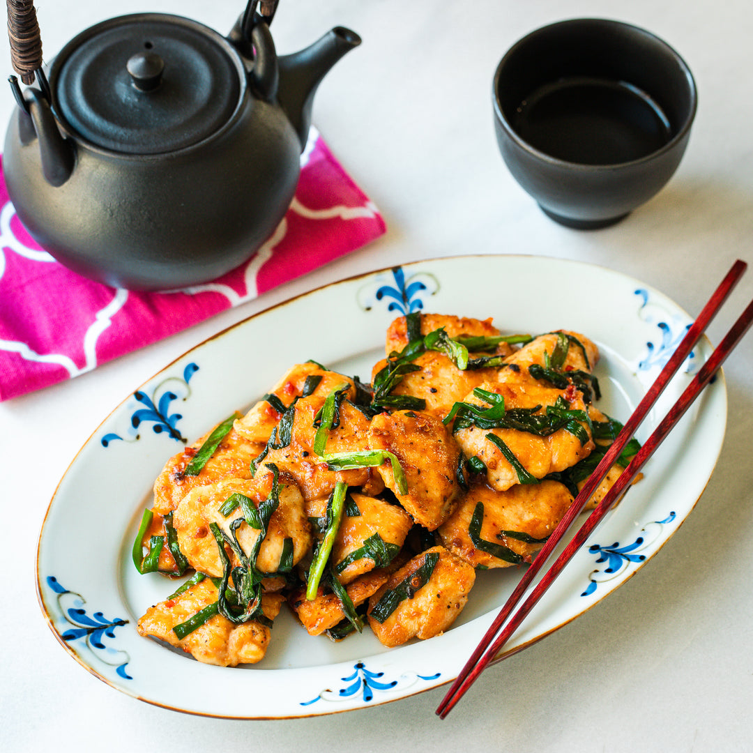 A delicious chicken and chive stir-fry presented on an elegant Floral Leaves Oval Dinner Plate.