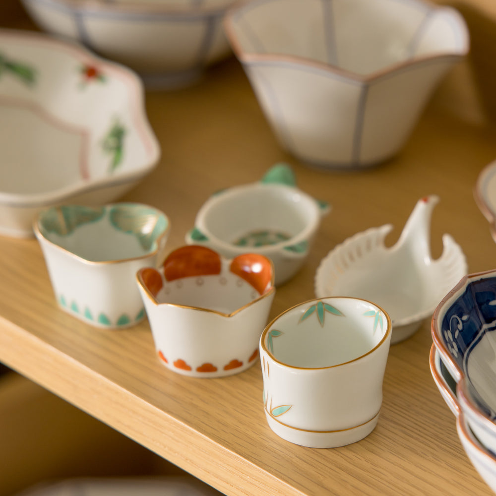 A white ceramic bowl with blue swirling patterns, traditional Japanese design.