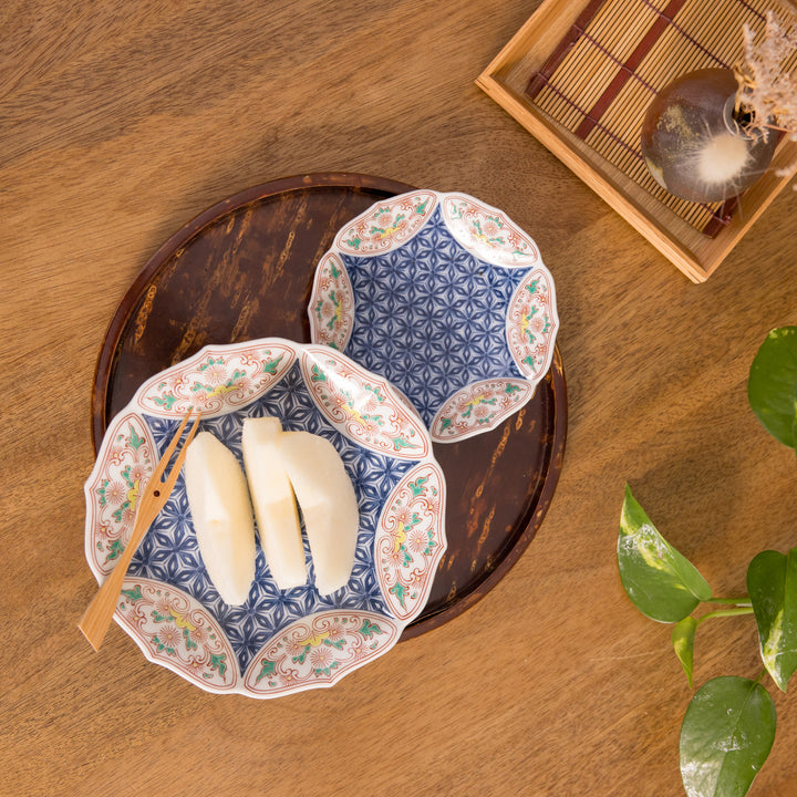 Two Bellflower Hemp Star dishes with a blue geometric design and orange floral details, placed on a wooden tray. 