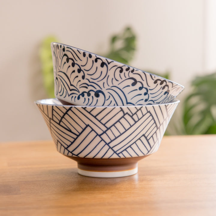 Stacked ceramic bowls featuring intricate blue wave and geometric patterns, designed with a subtle touch of elegance.