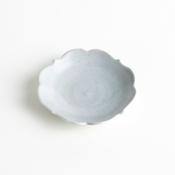 A small ceramic plate with a cloud-like shape, featuring a smooth white finish.