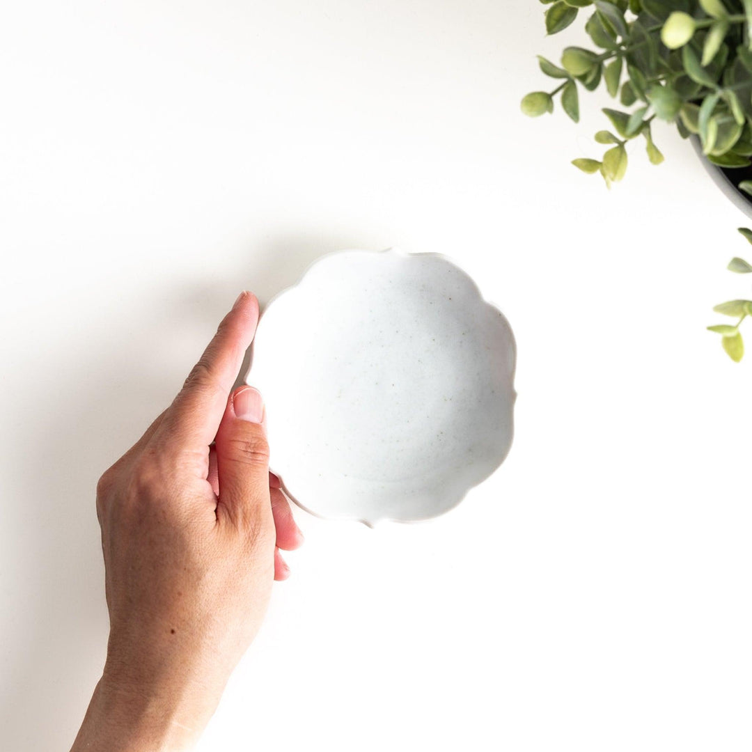 A small ceramic plate with a cloud-like shape, featuring a smooth white finish.