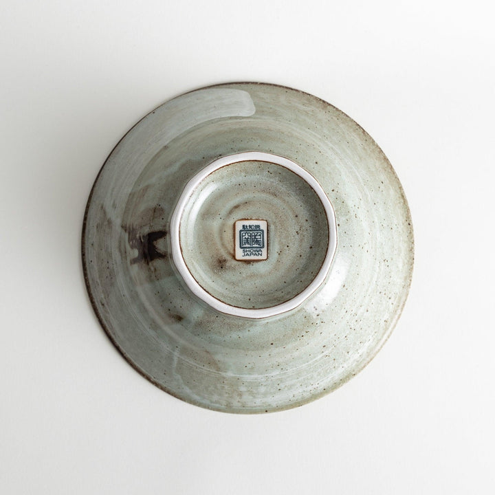 A light gray, wide-rimmed bowl with a textured and speckled surface.