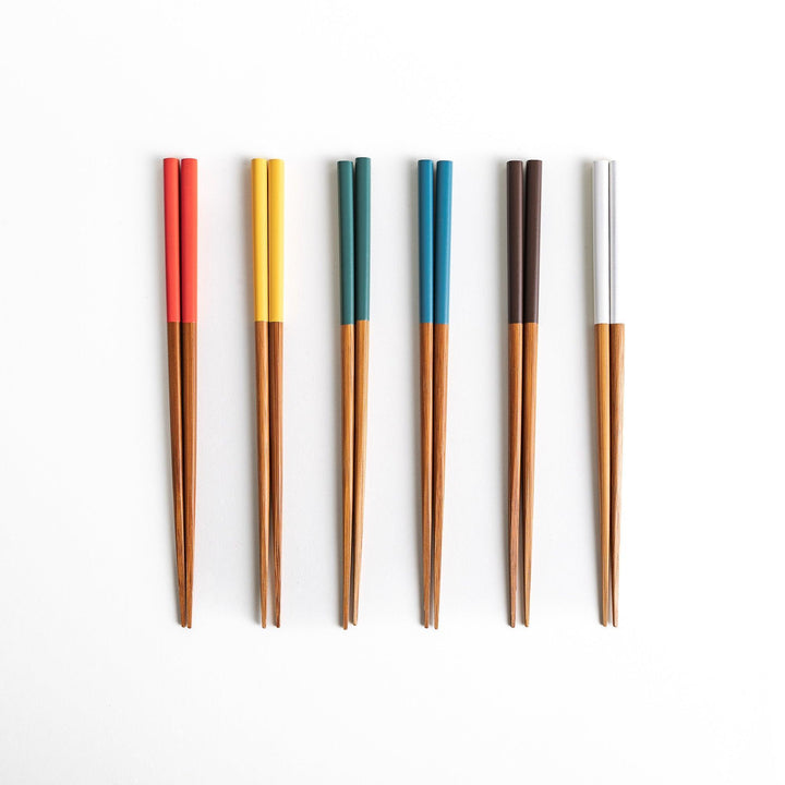 A set of wooden chopsticks with vibrant colored tops in various shades, including yellow, blue, orange, green, and white.