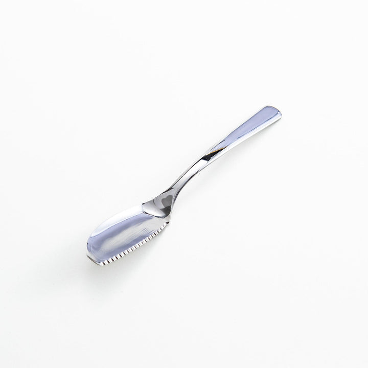 Stainless steel spreader knife with a serrated edge and sleek design