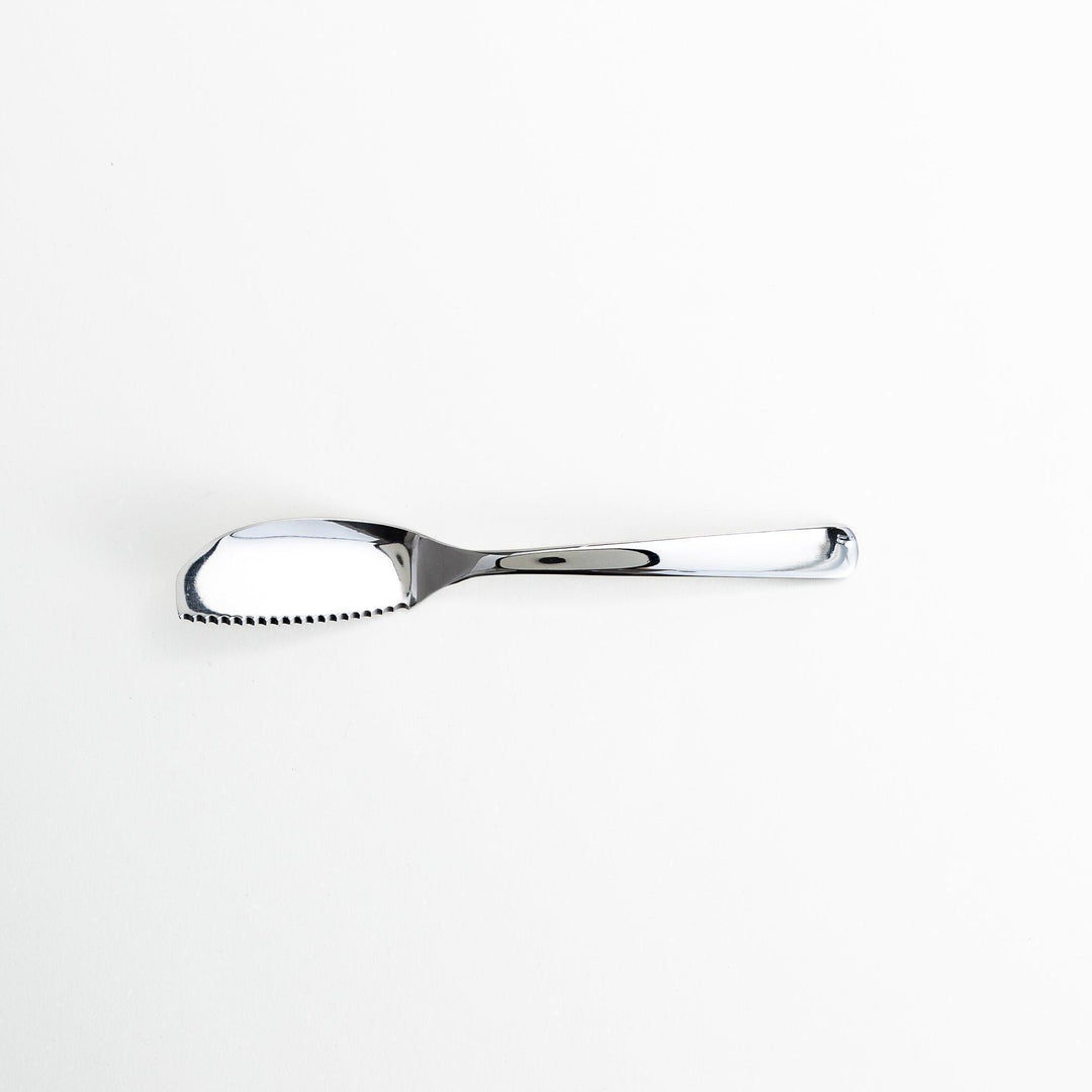 Stainless steel spreader knife with a serrated edge and sleek design