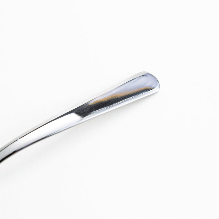 Stainless steel spreader knife with a serrated edge and sleek design