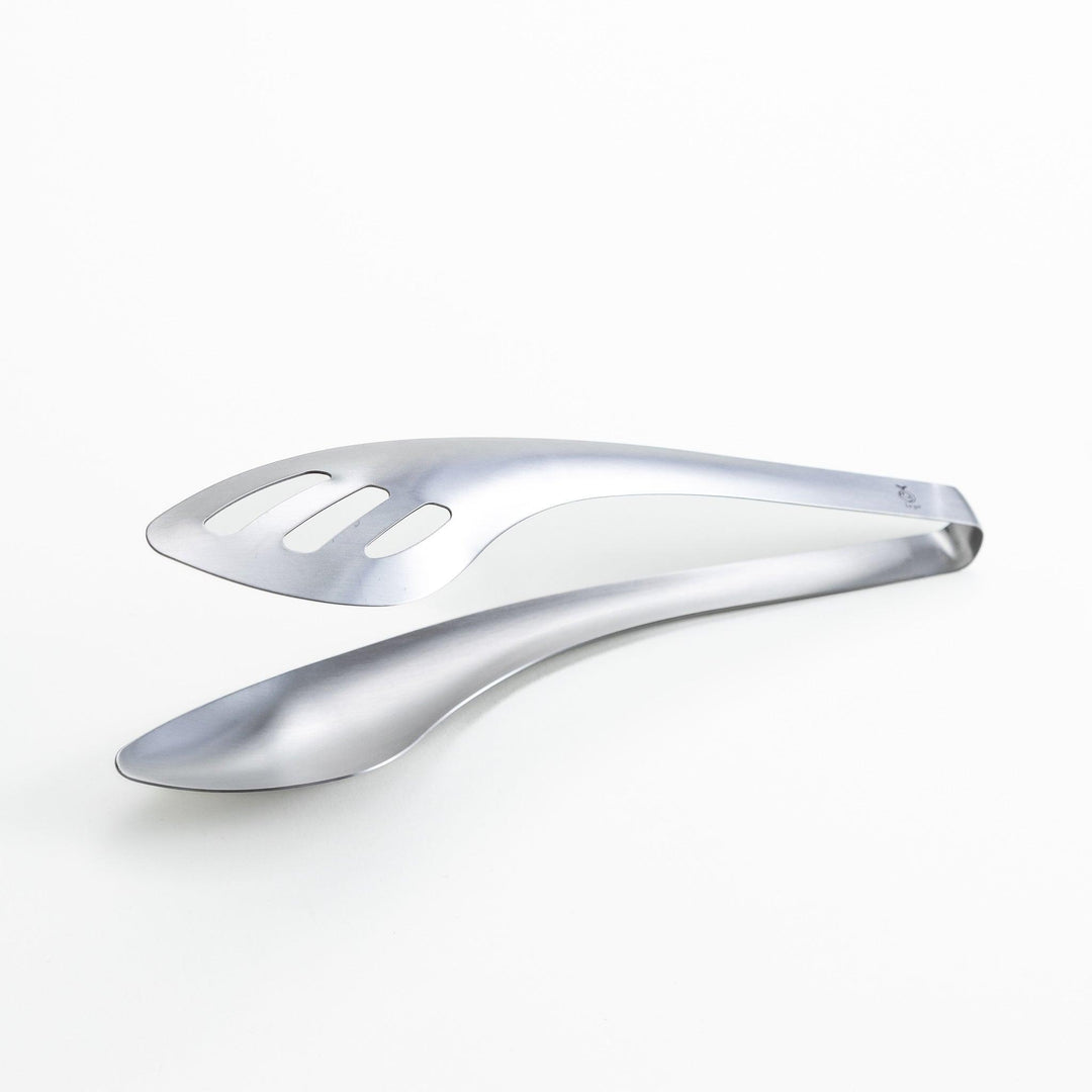 Sleek and modern stainless steel tongs with a slotted spoon end for draining and a solid spoon end for serving, perfect for handling salads, pasta, and other dishes with ease.