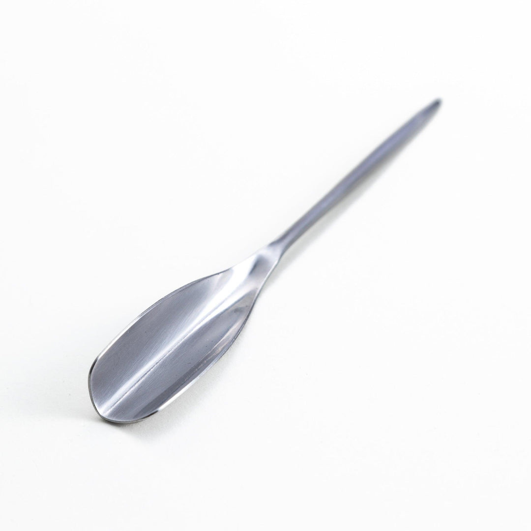 Long-handled stainless steel honey spoon with a uniquely shaped flat scoop