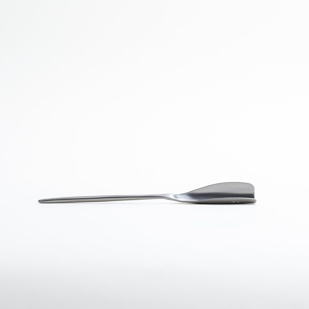 Long-handled stainless steel honey spoon with a uniquely shaped flat scoop