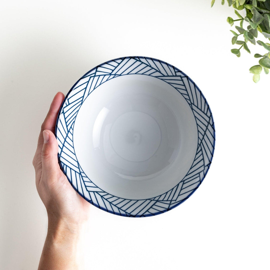 Basket weave patterned bowl with intricate blue geometric lines on a white background, featuring a brown base.