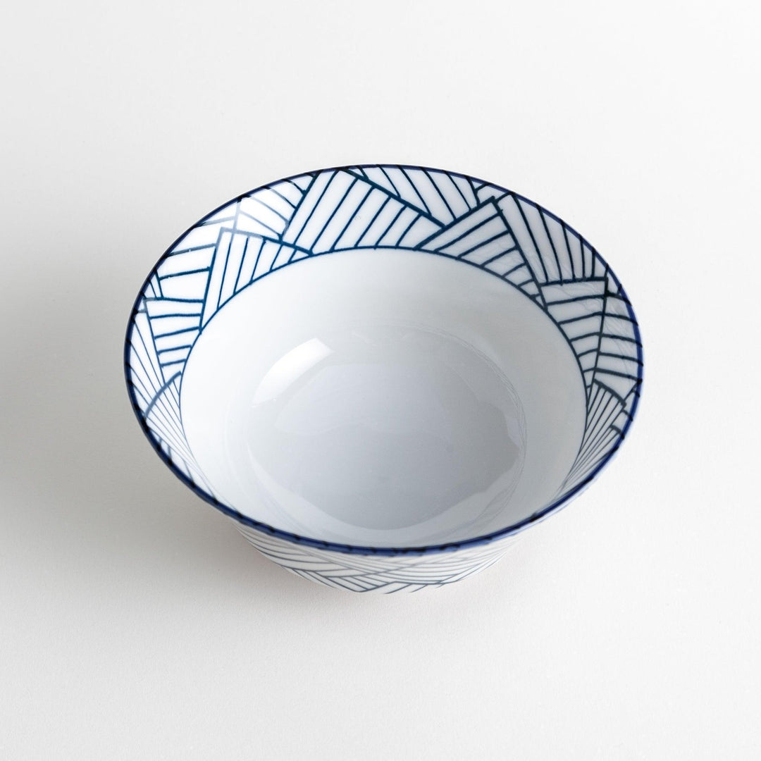 Basket weave patterned bowl with intricate blue geometric lines on a white background, featuring a brown base.