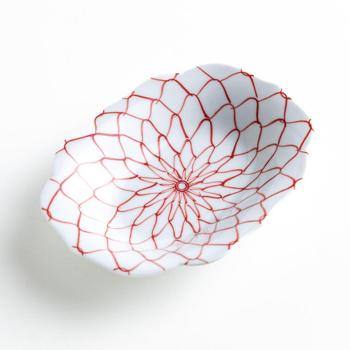 White dessert plate with a bowl shape featuring a blue or red net-like pattern