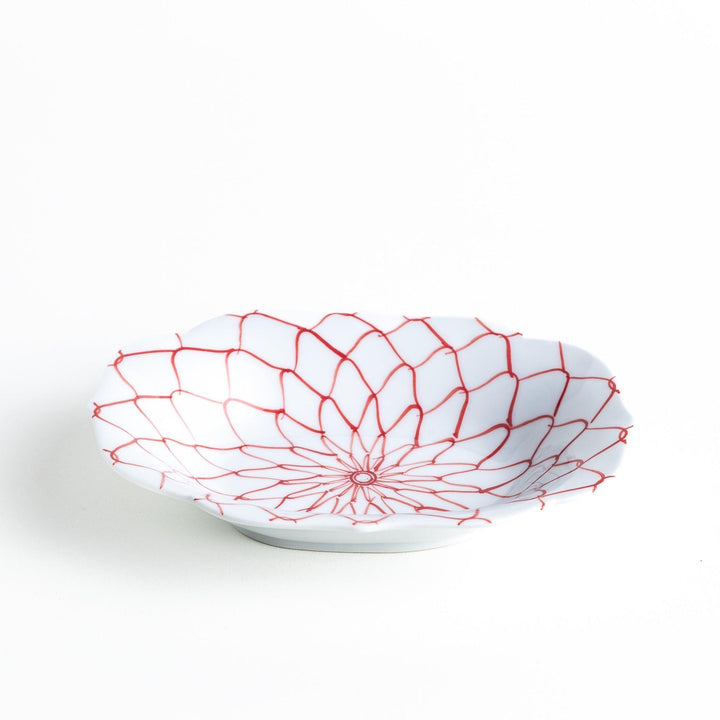 White dessert plate with a bowl shape featuring a blue or red net-like pattern