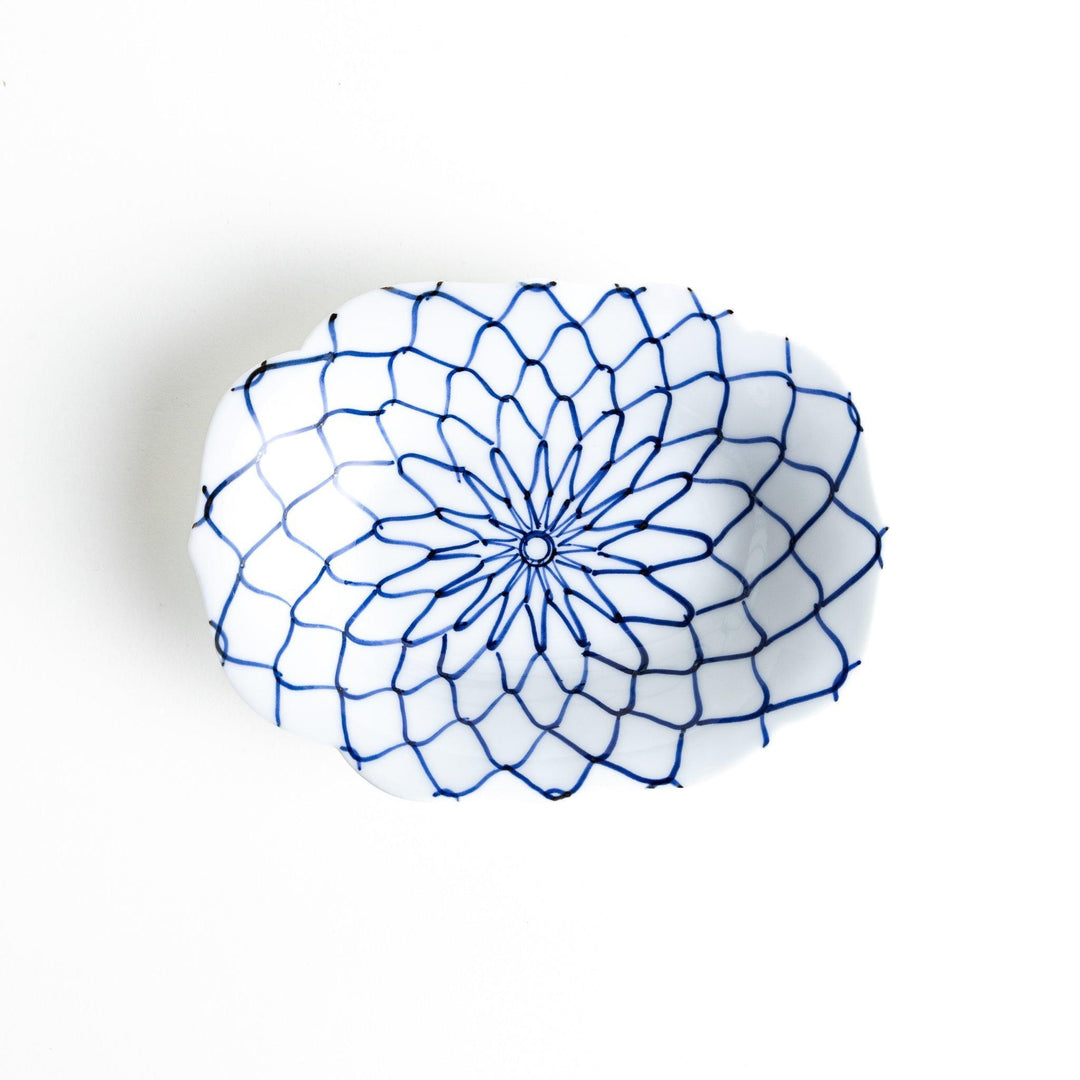 White dessert plate with a bowl shape featuring a blue or red net-like pattern