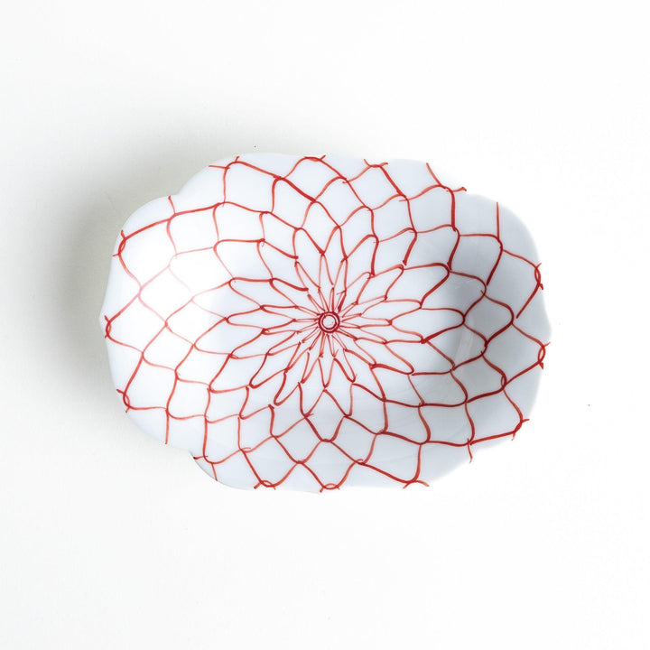 White dessert plate with a bowl shape featuring a blue or red net-like pattern