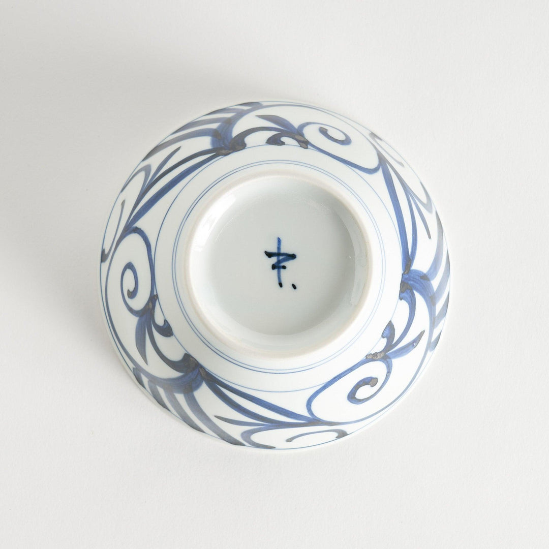 A white ceramic bowl with blue swirling patterns, traditional Japanese design.