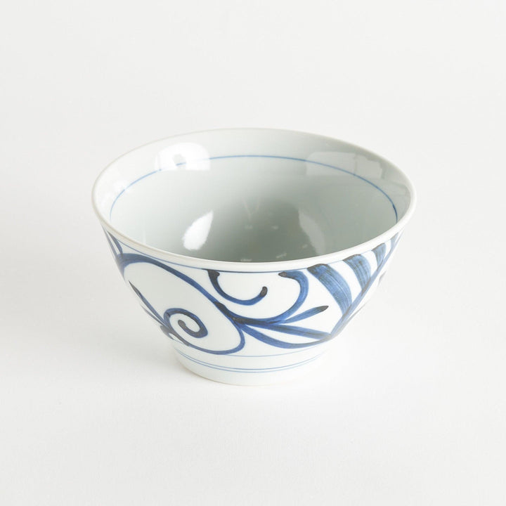 A white ceramic bowl with blue swirling patterns, traditional Japanese design.