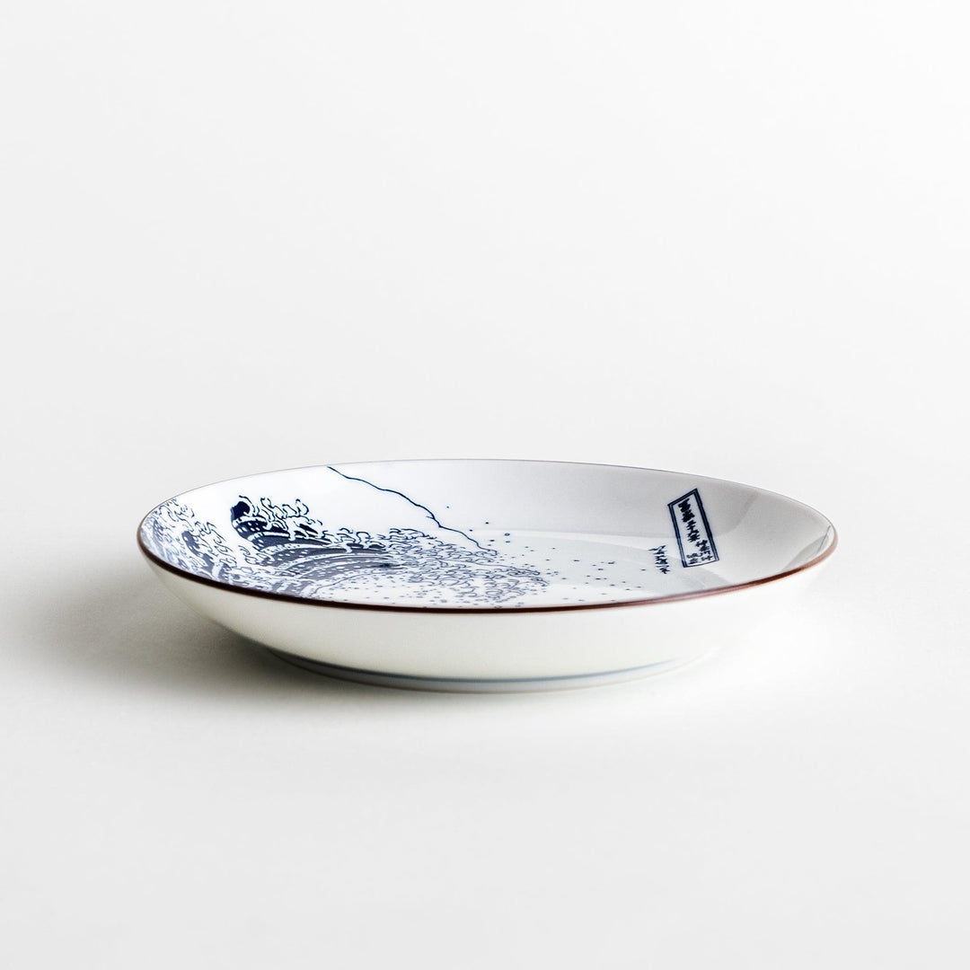 A round plate featuring the famous "Great Wave" artwork in blue on a white background.