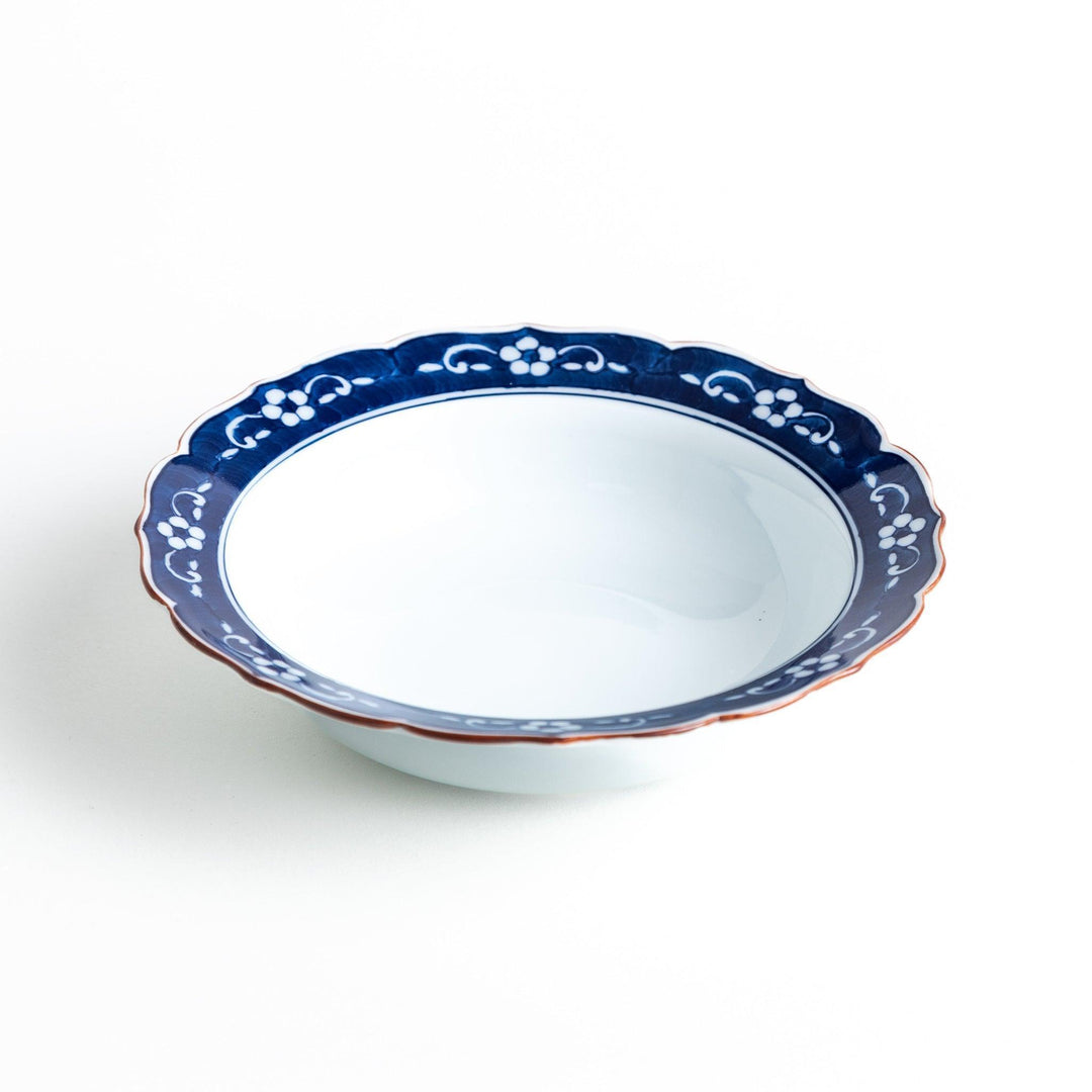 A ceramic bowl with a blue floral pattern around the rim.