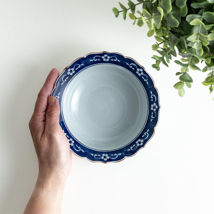 A ceramic bowl with a blue floral pattern around the rim.