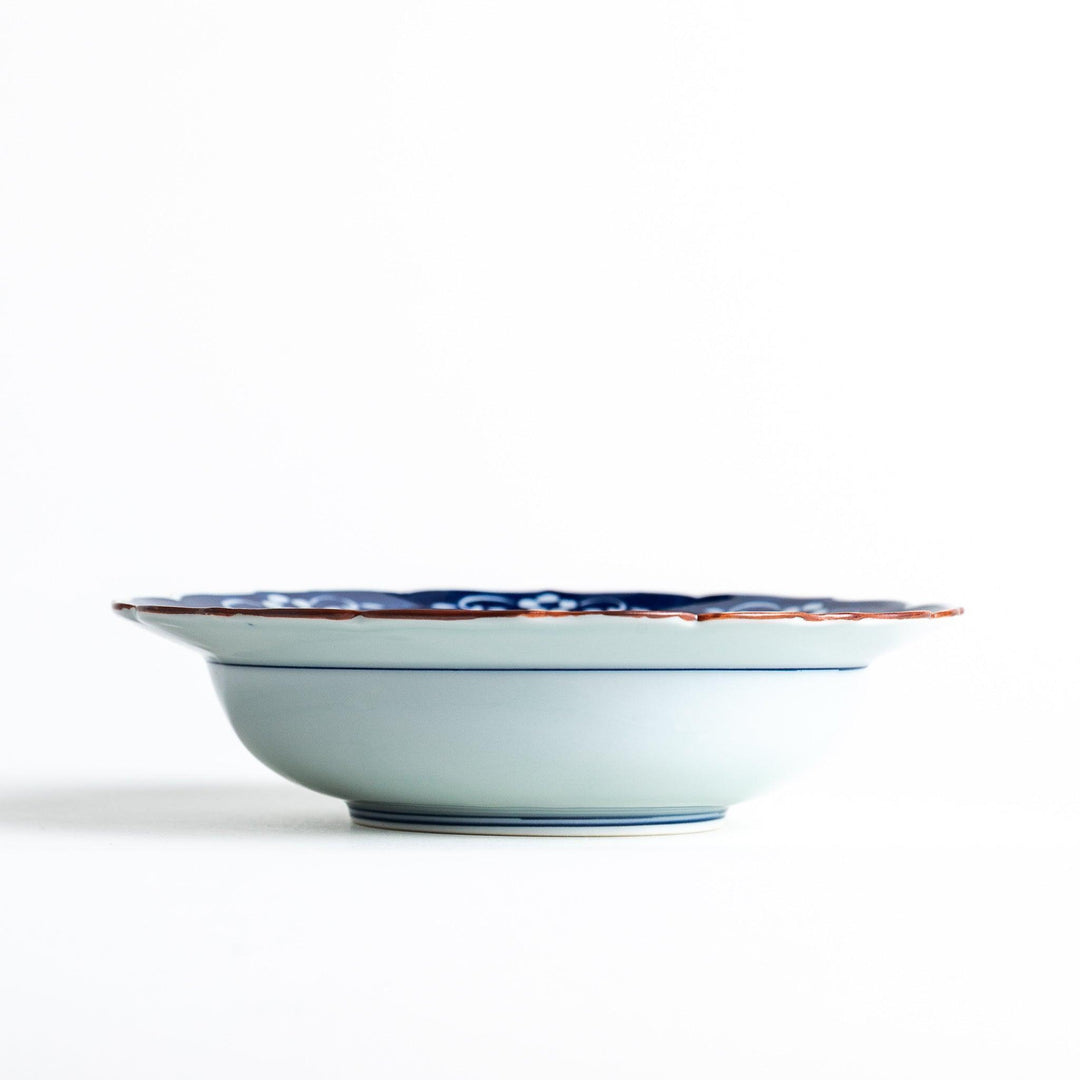 A ceramic bowl with a blue floral pattern around the rim.