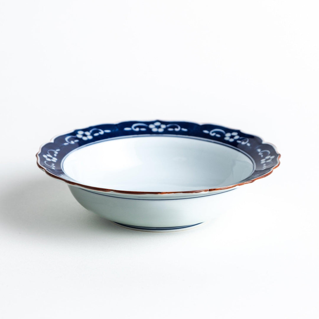 A ceramic bowl with a blue floral pattern around the rim.