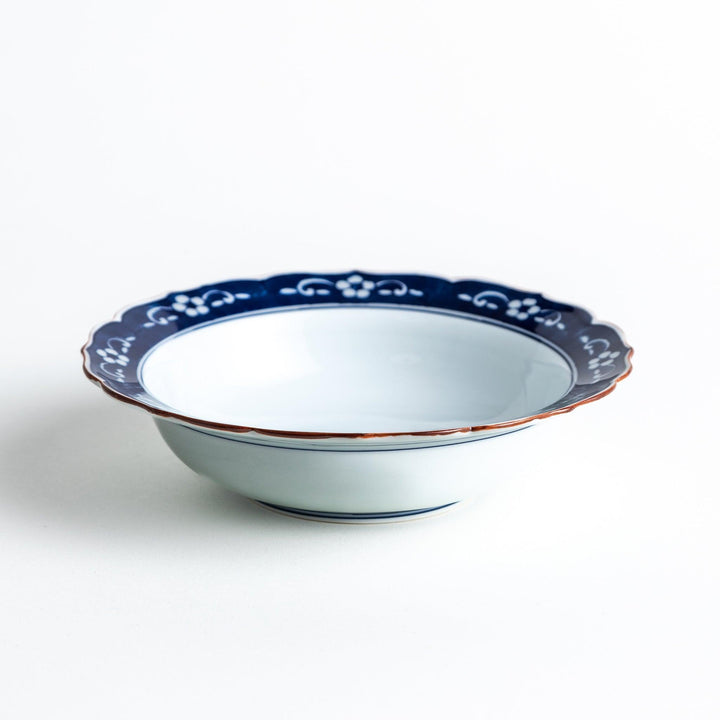 A ceramic bowl with a blue floral pattern around the rim.