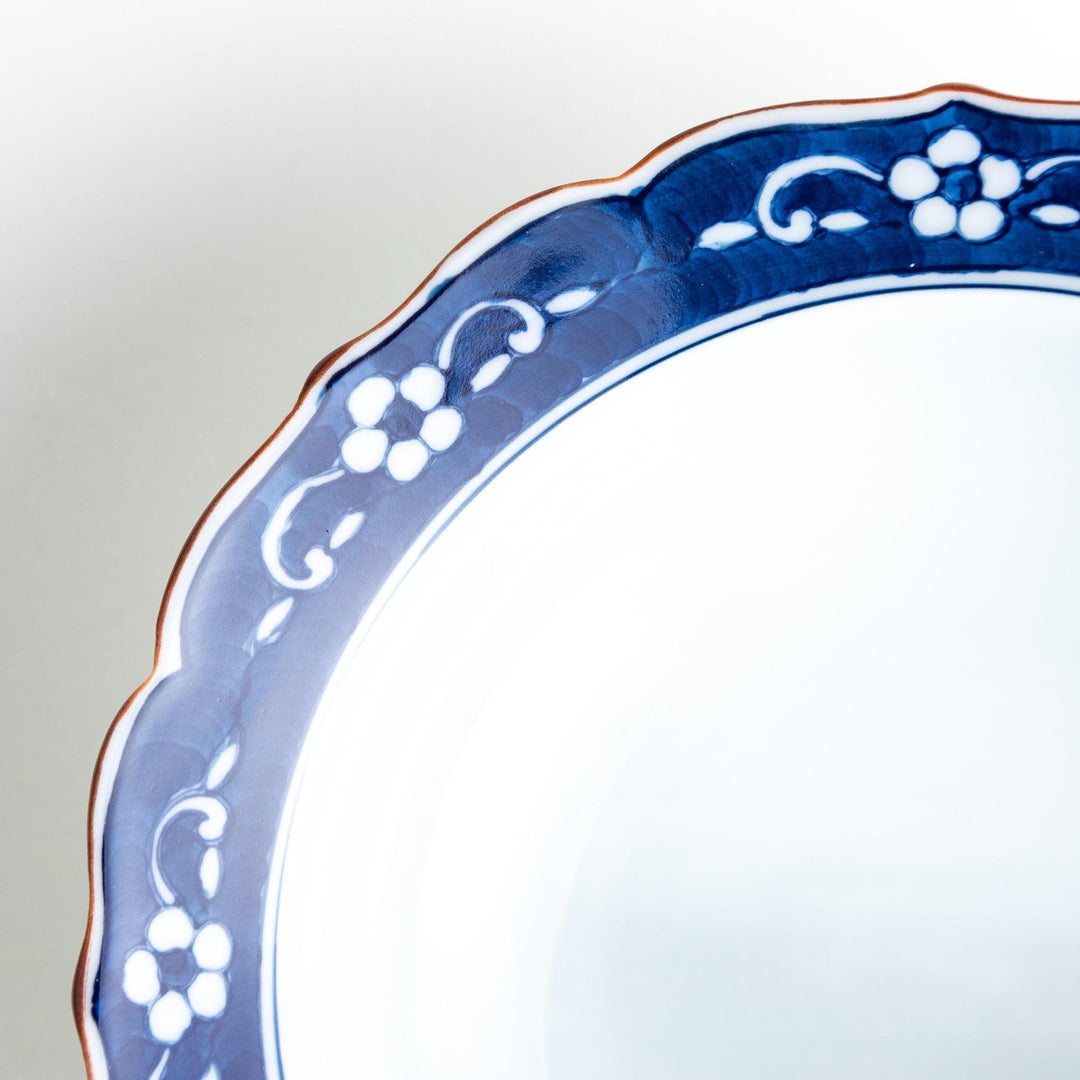 A ceramic bowl with a blue floral pattern around the rim.