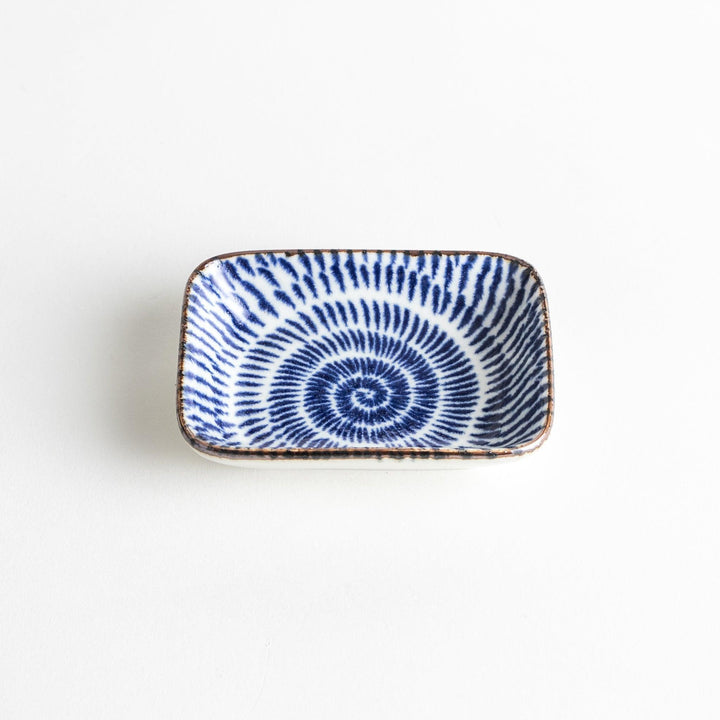 A small rectangular dish featuring a traditional Japanese design with a blue spiral pattern on a white background.