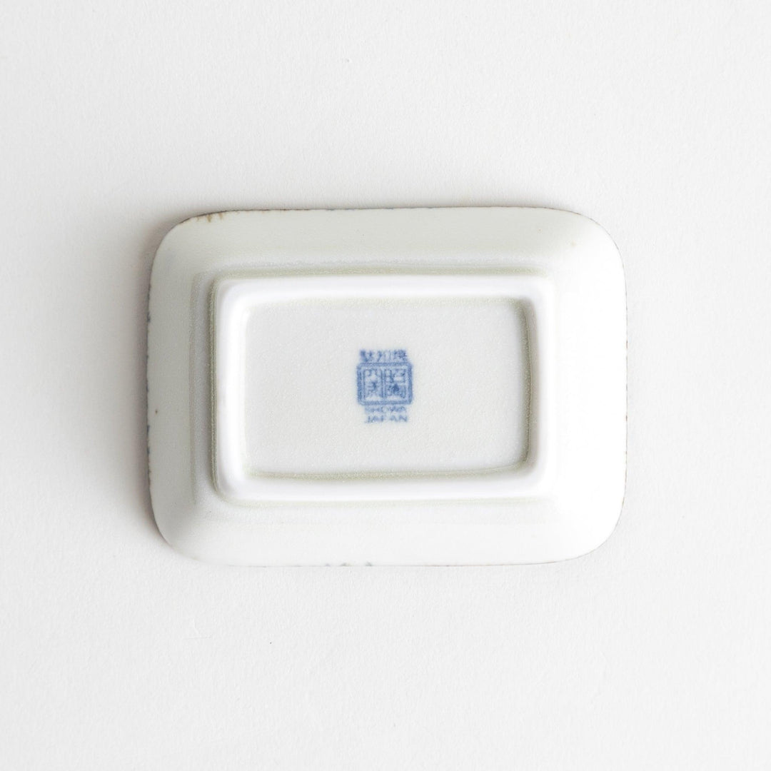 A small rectangular dish featuring a traditional Japanese design with a blue spiral pattern on a white background.