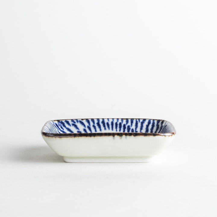 A small rectangular dish featuring a traditional Japanese design with a blue spiral pattern on a white background.