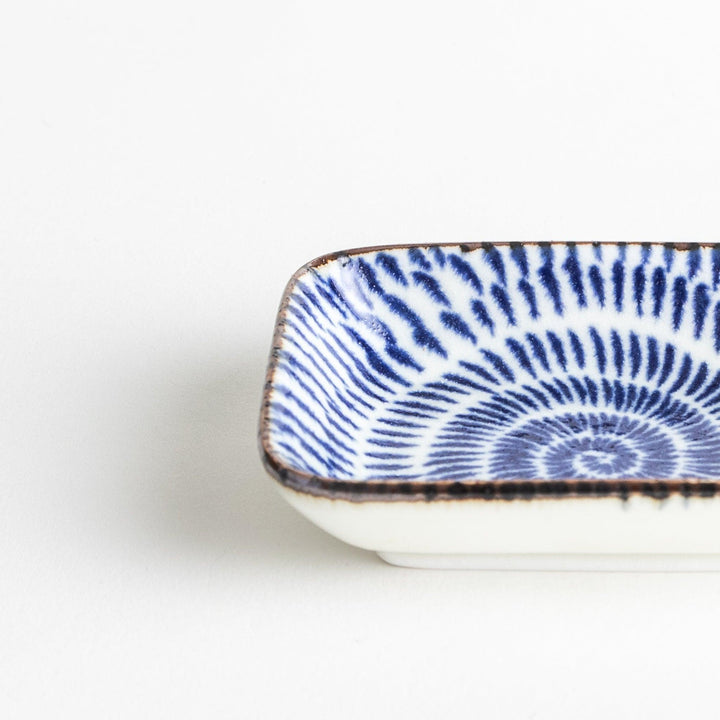 A small rectangular dish featuring a traditional Japanese design with a blue spiral pattern on a white background.