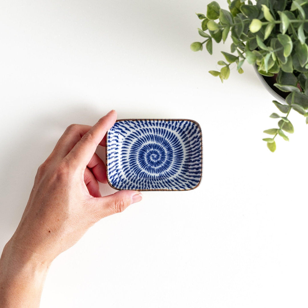 A small rectangular dish featuring a traditional Japanese design with a blue spiral pattern on a white background.