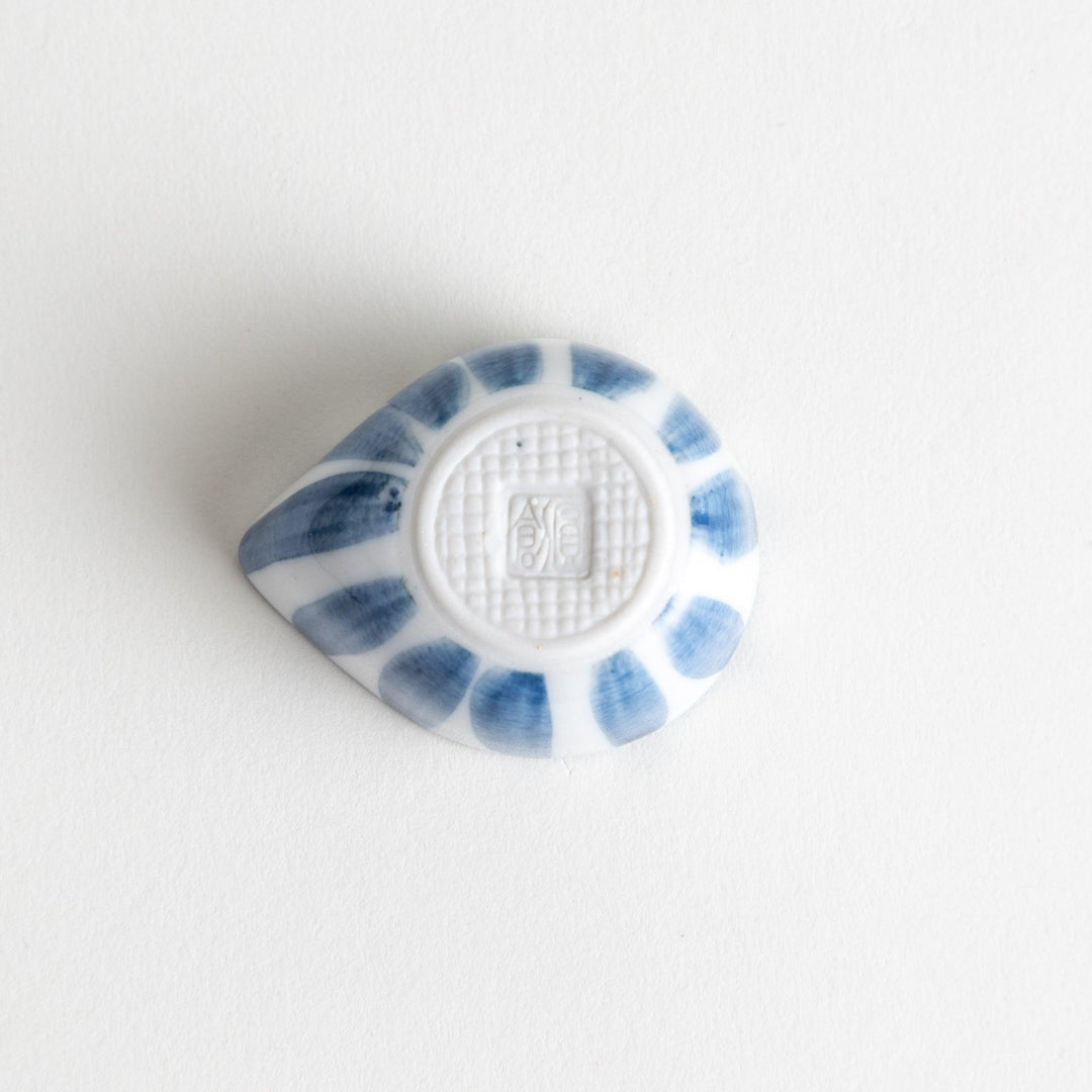 A small condiment bowl with a distinct blue and white vertical stripe pattern.