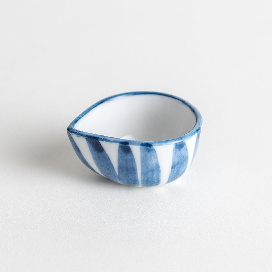 A small condiment bowl with a distinct blue and white vertical stripe pattern.