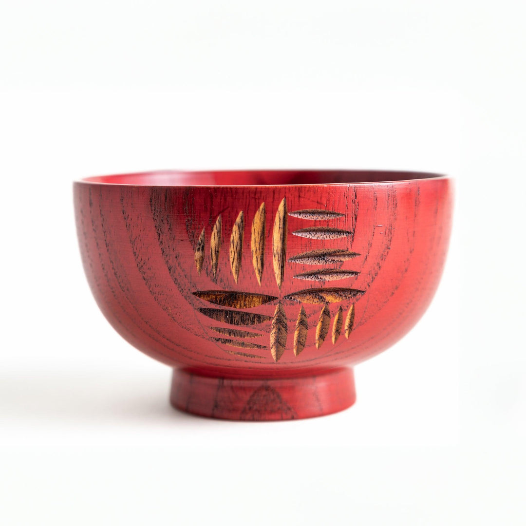 A traditional lacquered wooden bowl featuring a hand-carved pattern of lines and geometric shapes. Available in black or red.