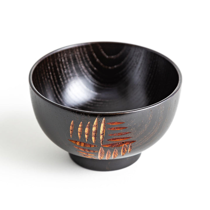 A traditional lacquered wooden bowl featuring a hand-carved pattern of lines and geometric shapes. Available in black or red.