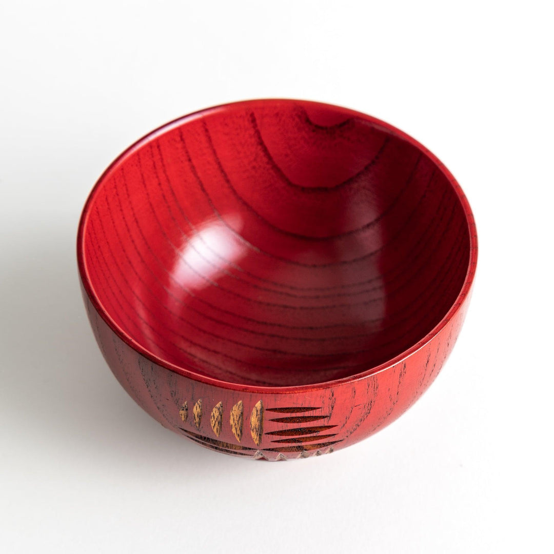 A traditional lacquered wooden bowl featuring a hand-carved pattern of lines and geometric shapes. Available in black or red.