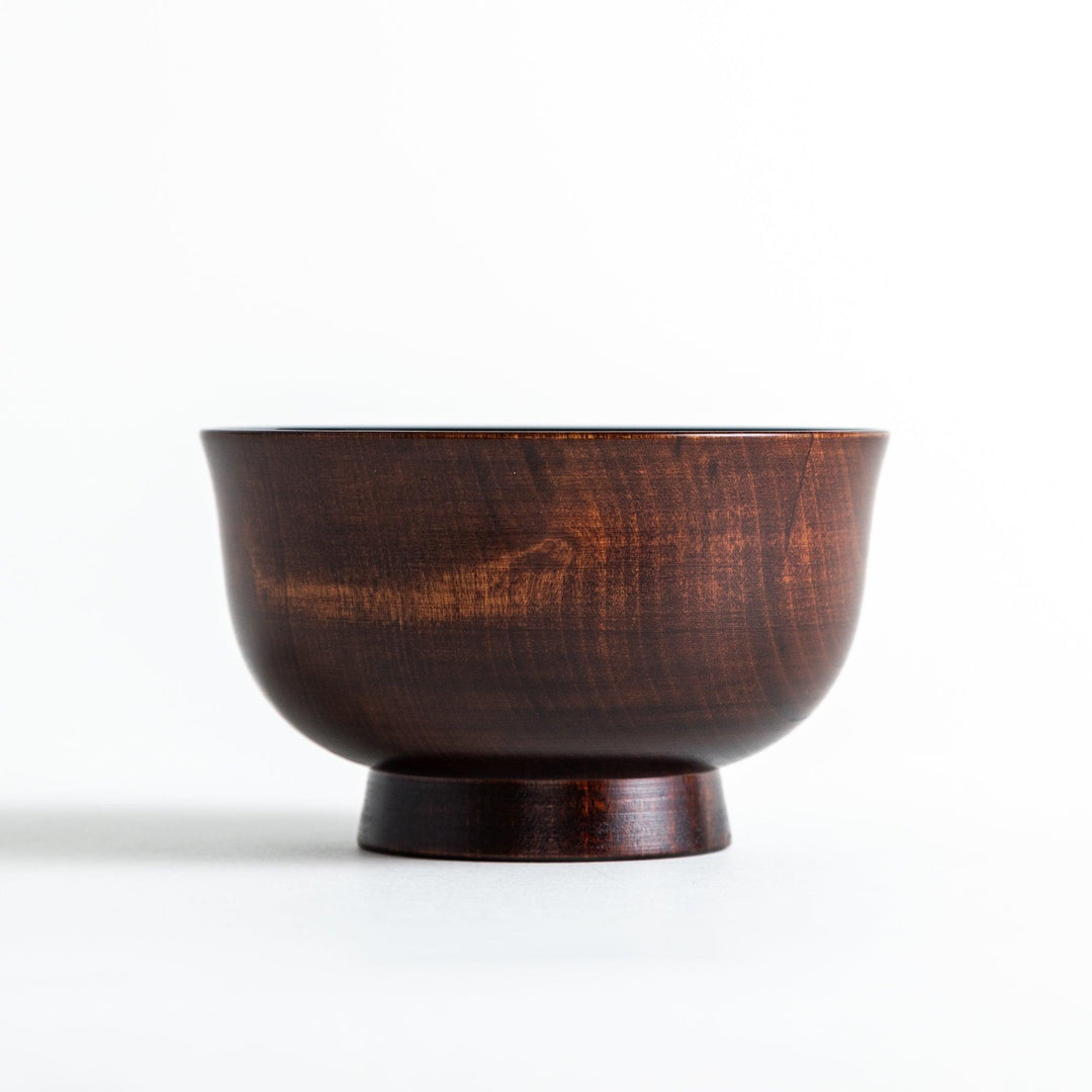 A wooden soup bowl featuring a dark brown grain finish with a sleek black interior.