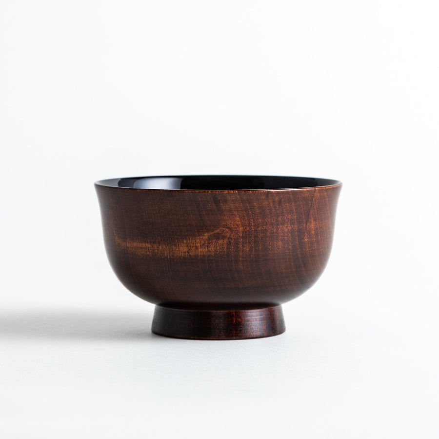 A wooden soup bowl featuring a dark brown grain finish with a sleek black interior.