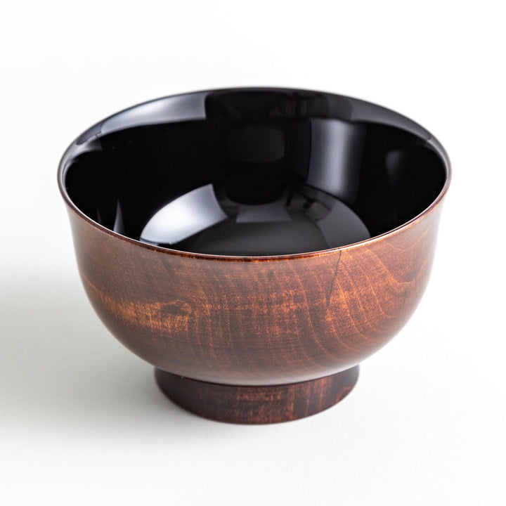 A wooden soup bowl featuring a dark brown grain finish with a sleek black interior.