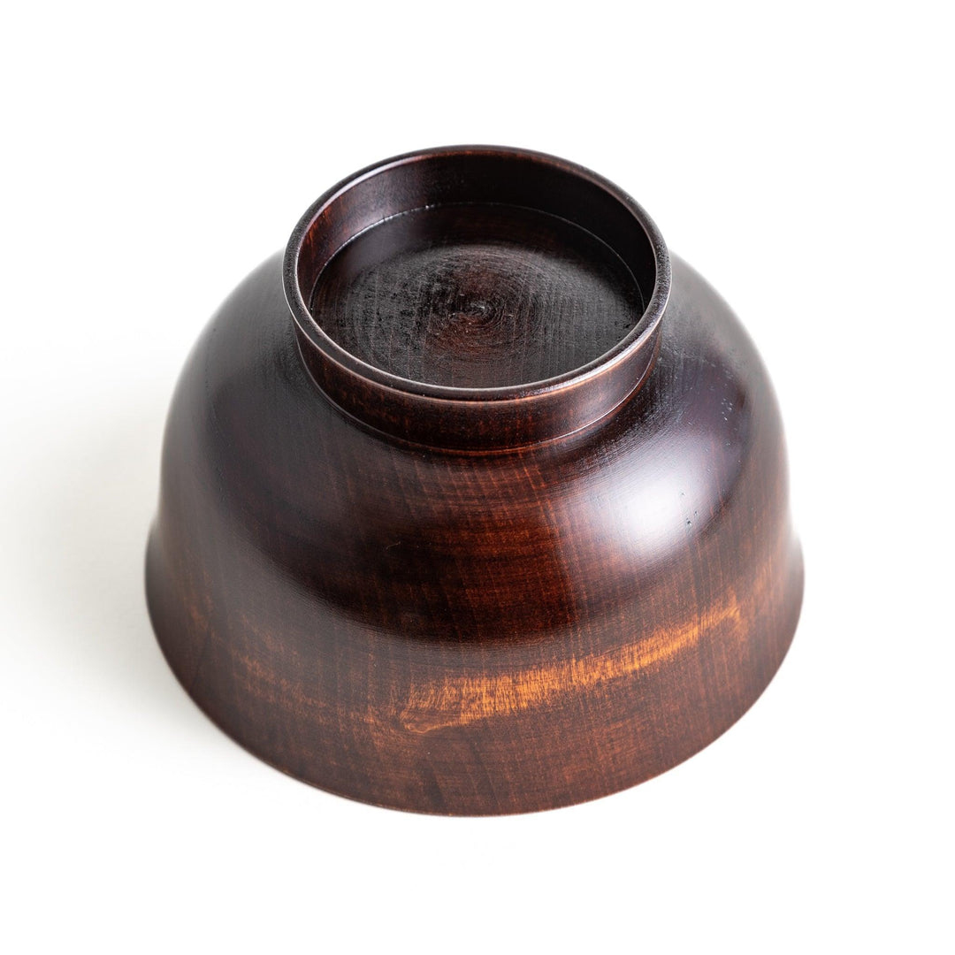 A wooden soup bowl featuring a dark brown grain finish with a sleek black interior.