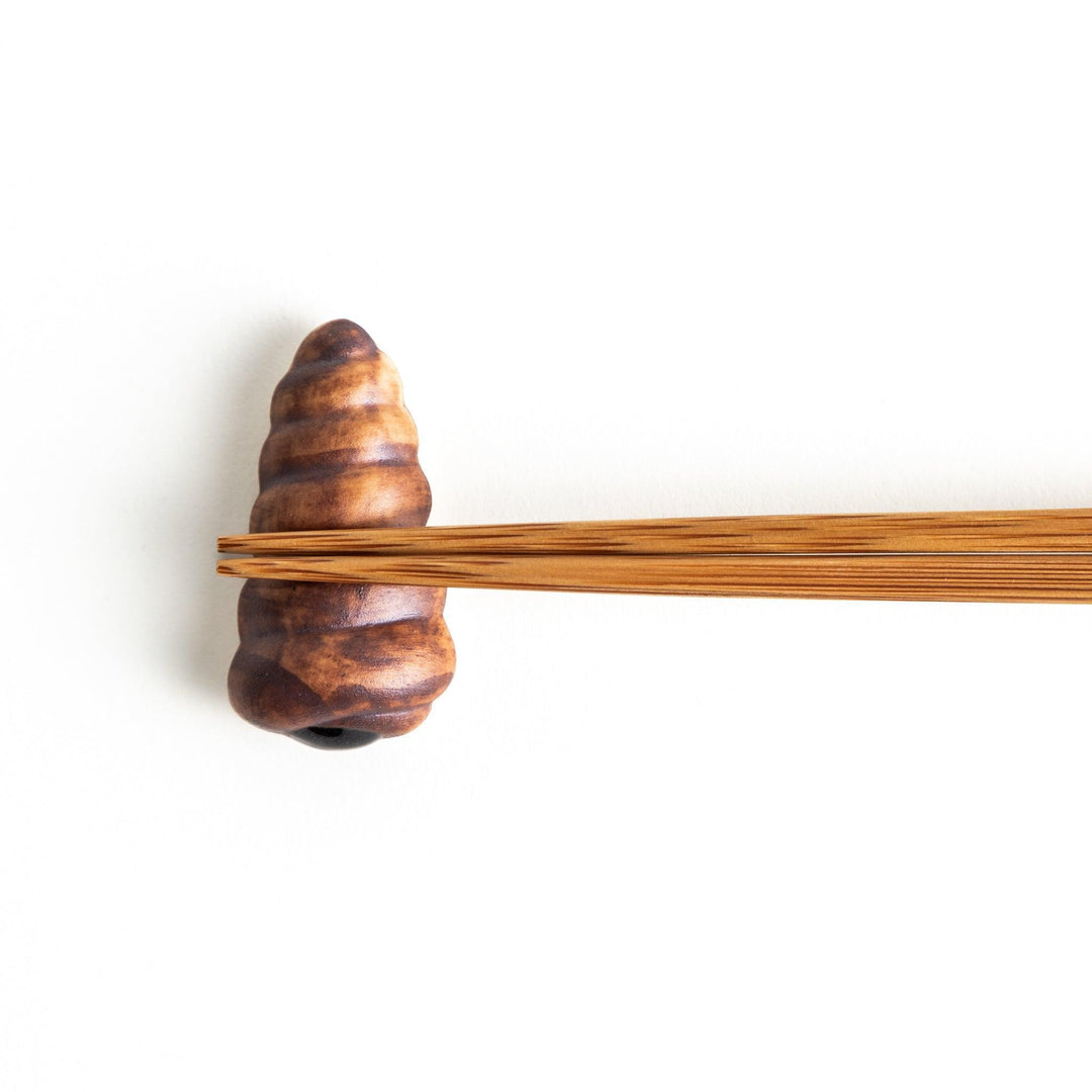 A ceramic chopstick rest resembling a chocolate cornet.