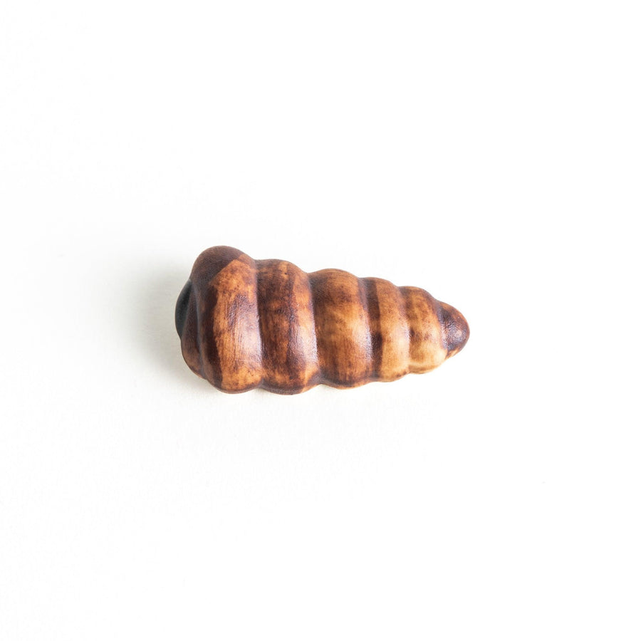 A ceramic chopstick rest resembling a chocolate cornet.