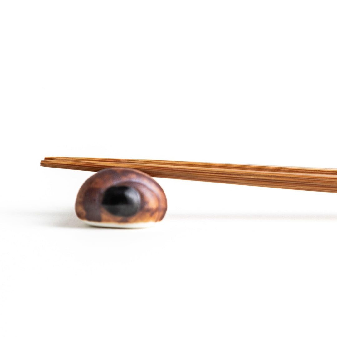 A ceramic chopstick rest resembling a chocolate cornet.