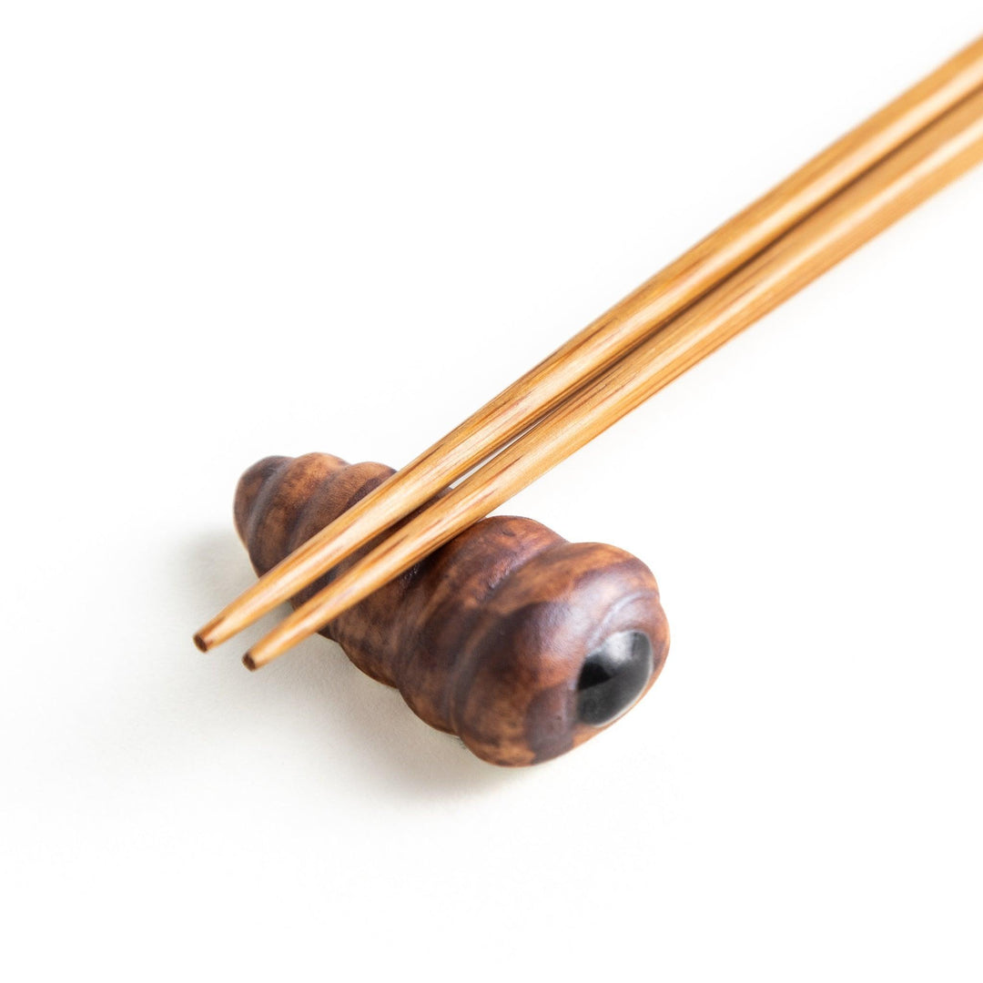 A ceramic chopstick rest resembling a chocolate cornet.