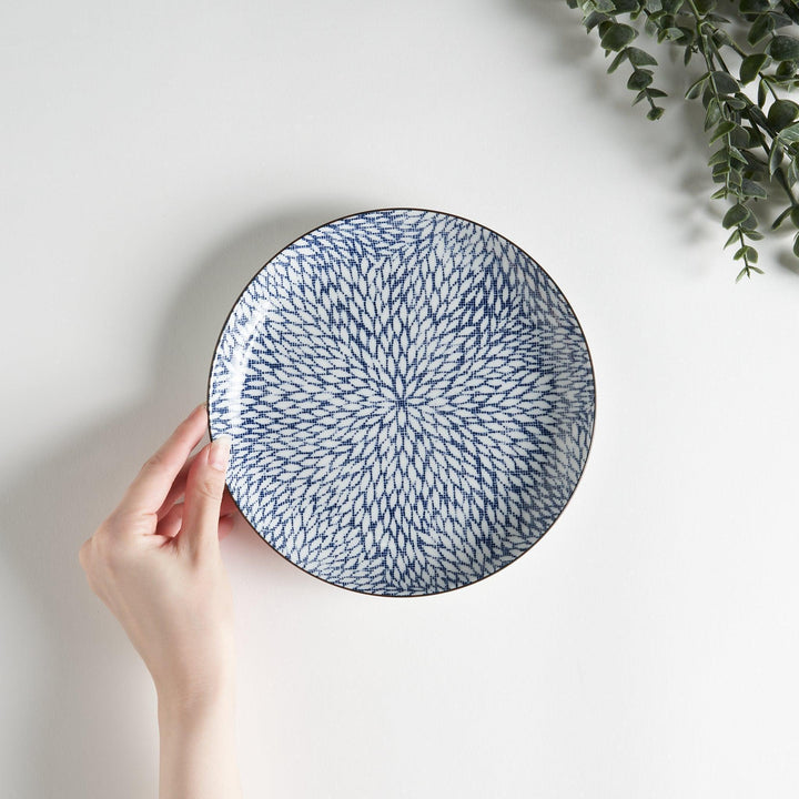 A salad plate with a detailed blue herringbone pattern radiating from the center.