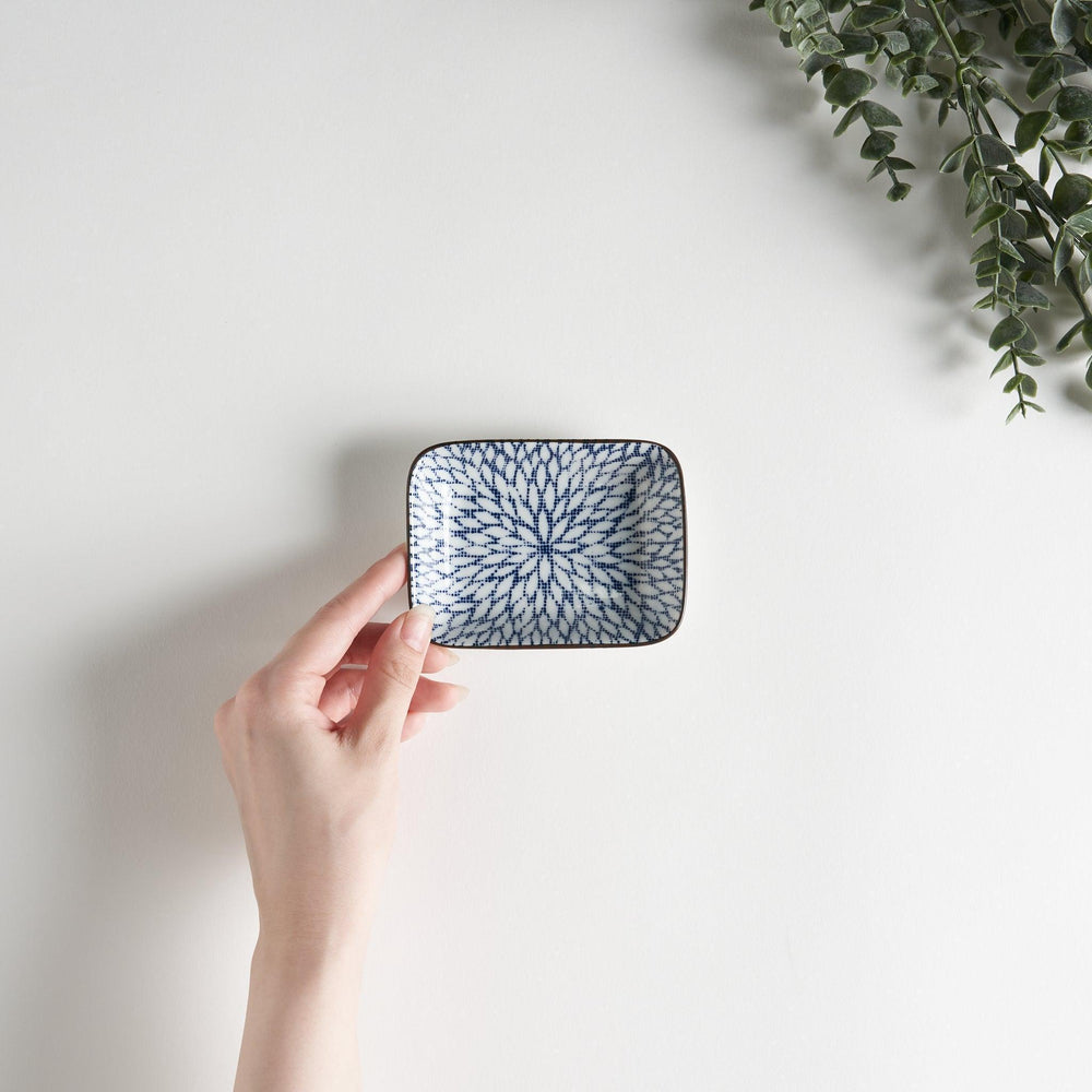 A small rectangular dish featuring a blue herringbone pattern on a white background.